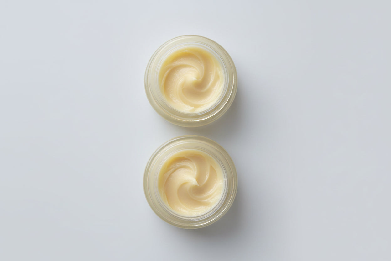 Two small containers of cream 