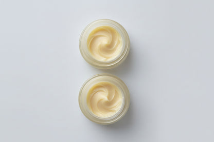 Two small containers of cream 